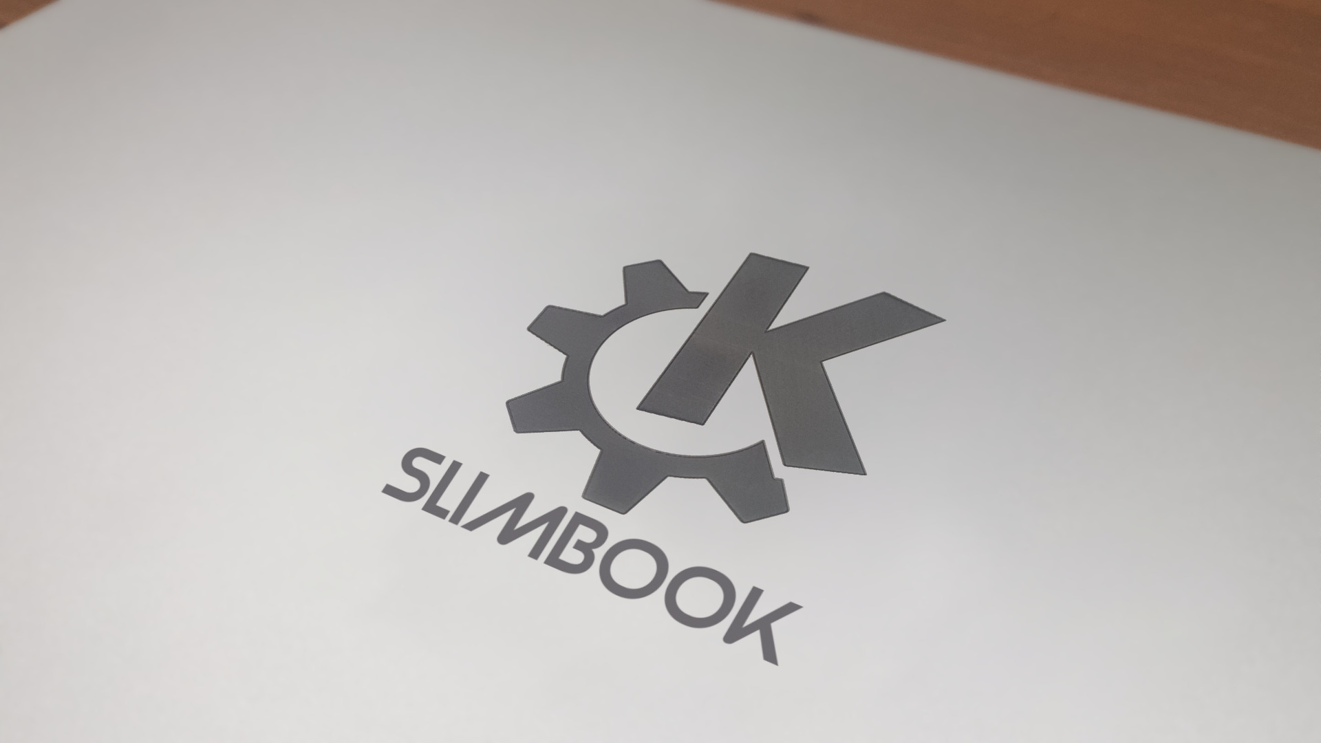 Cover of a Slimbook computer diaplying the KDE logo.